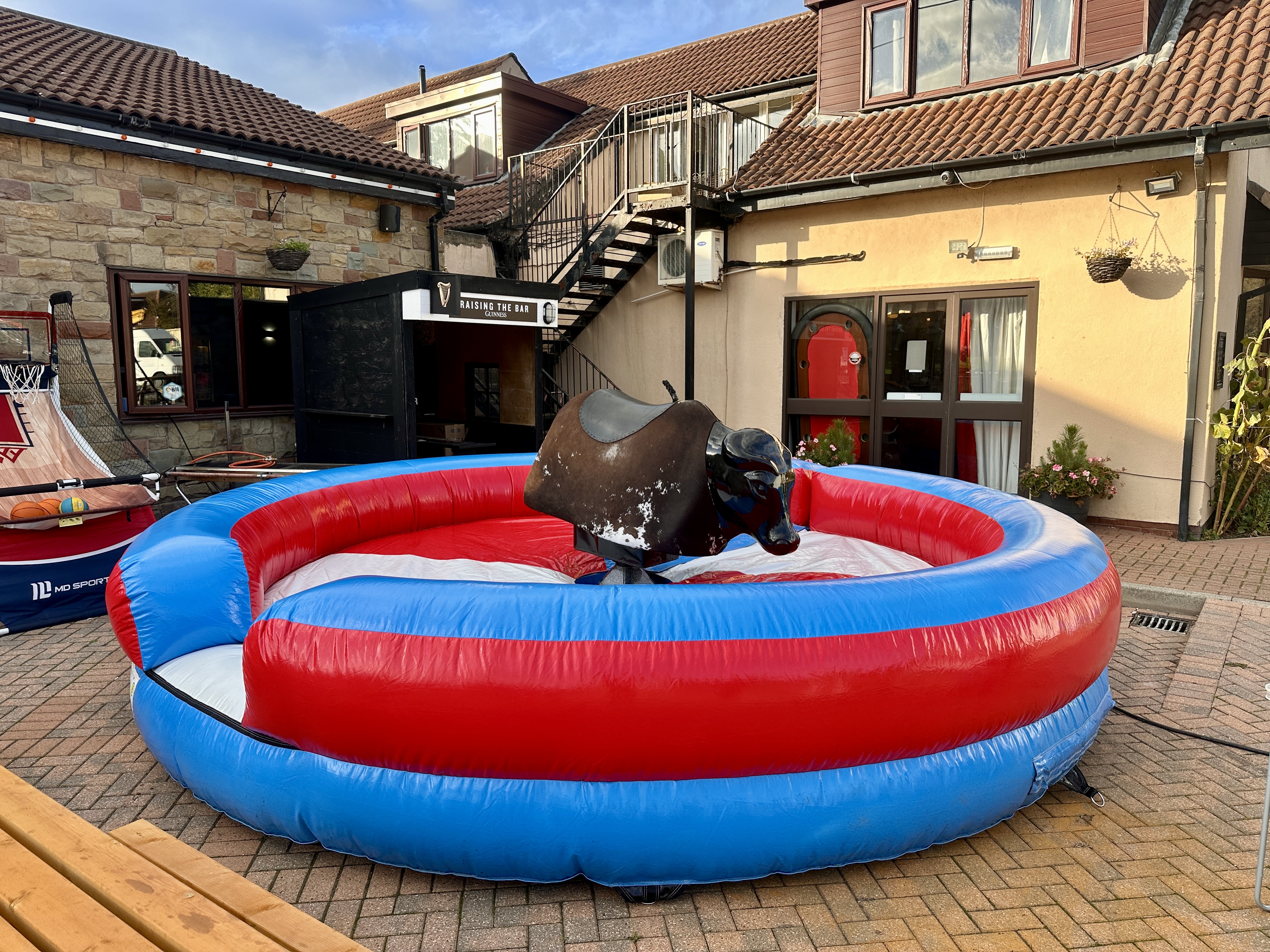 Mechanical bull ride with inflatable fall zone — Sheffield hire